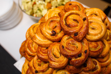Freshly Baked Traditional Sweet Cinnamon Rolls, Swirl on white wooden board.