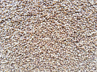 Food texture background from brown buckwheat. Stock photo.