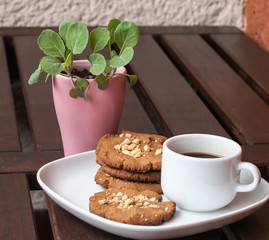 cookies, coffee and plant on the wooden desk