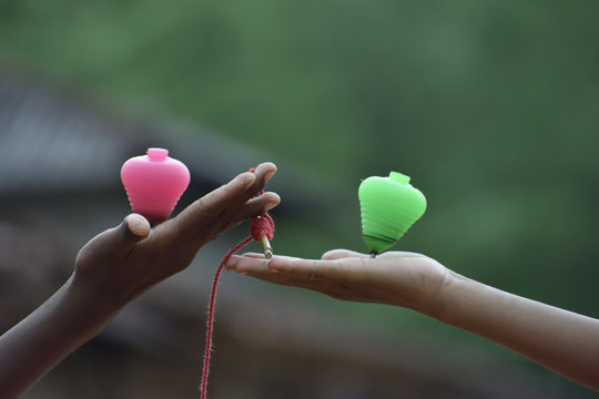 hand holding a pink rose or lattu