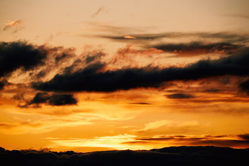 Beautiful landscape of nature and orange sunset in the sky with clouds and horizon in the evening. Colored background at the bottom