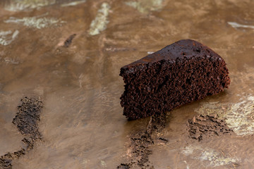Close-up of slice of chocolate cake, on antique marble surface