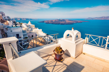 Sunny morning view of Santorini island. Brigt summer scene of famous Greek resort Fira, Greece, Europe. Amazing Mediterranean seascape. Traveling concept background.