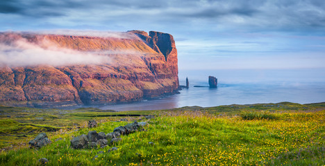 Astonishing summer scene of popular tourist attraction - Risin og Kellingin cliffs. Panaramic...