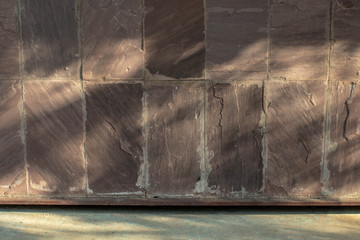 dark sandstone tile background in warn light