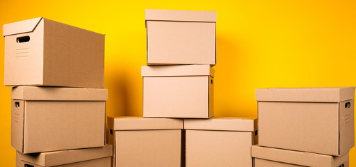 Boxes with delivery service packages on a yellow background