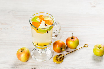 Apple and orange lemonade in a transparent glass cup