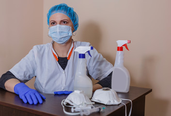 A female doctor in a sterile mask and uniform on a break after prevention during the covid-19...