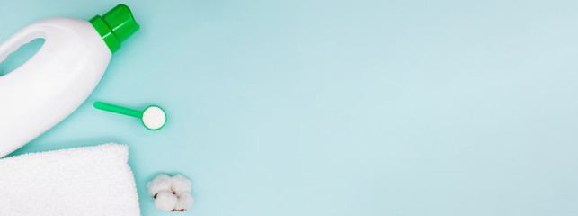 Laundry set with towels, washing powder and plastic botte on blue background