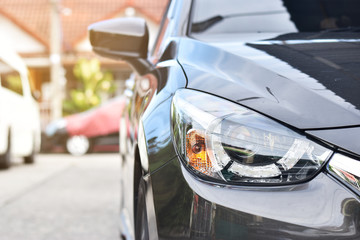 Naklejka premium New aggressive headlight by night. Car details. The front lights of the sports car.