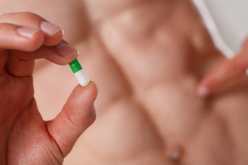 Athlete bodybuilder takes dope in the form of tablets form of pharma rapid progress in muscle...