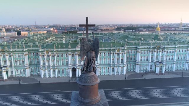 Aerial behind back Alexander Column angel on steel cross. St. Petersburg Winter Palace Hermitage sunrise square. Historical epic dramatic cityscape downtown. Travel tourism best sight. Flight. 4k