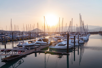 Sunset Marina. Boats & yachts docked at sea. Airlie beach boat harbour waterfront sunset view....