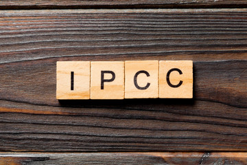 IPCC word written on wood block. abbreviation Intergovernmental Panel on Climate Change text on wooden table for your desing, concept