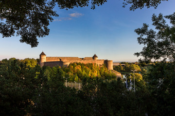 Fototapeta na wymiar Russia, Ivangorod. Panoramic view of the Ivangorod fortress on the border of Russia and Estonia on the banks of the Narva River