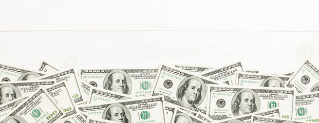 Top view banknotes on colored desk with copy space on top. one hundred dollar bills with stack of...