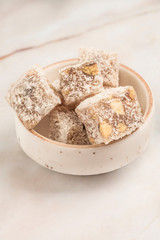 Turkish delights with pistachio in a bowl on a table