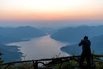 The tourist enjoy with landscape view of beautiful sunrise on big river and mountain view point