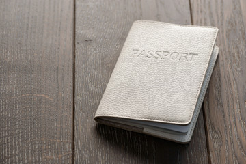 Close up on a passport on wooden background