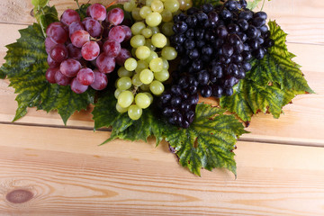 Grape and leaves on table