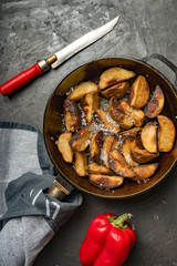 Close-up of baked or fried potatoes. Rustic style.