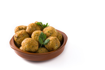 Traditional cod fritters in clay bowl isolated on white background. Copy space