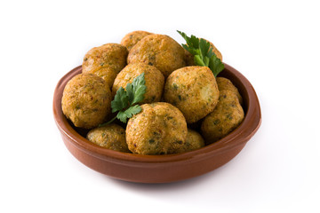 Traditional cod fritters in clay bowl isolated on white background