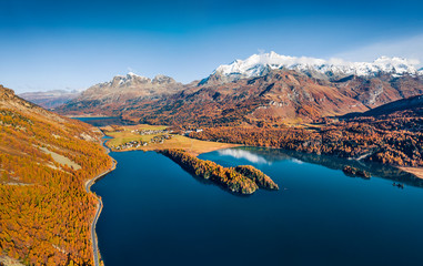 View from flying drone. Unbelievable autumn view of Sils lake. Wonderful morning scene of Swiss Alps. Spectacular outdoor scene of Switzerland, Europe. Beauty of nature concept background.