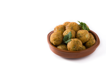 Traditional cod fritters in clay bowl isolated on white background. Copy space