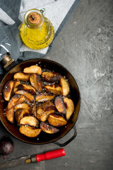Close-up of baked or fried potatoes. Rustic style.