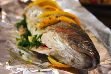 Trout fish filled by orange, herbs and spices and ready to cook