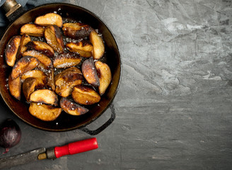 Close-up of baked or fried potatoes. Rustic style.