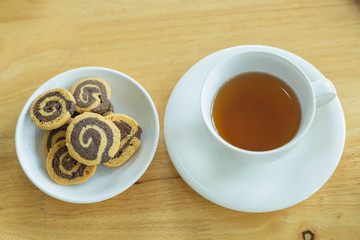 Cup of tea with oatmeal cookies on a wooden background