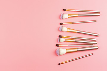 Cosmetic Makeup brushes on pink background. Flat lay, top view, copy space. Makeup accessories, mockup, template