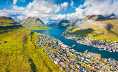 View from flying drone. Captivating summer cityscape of Klaksvik town. Aerial morning scene of...