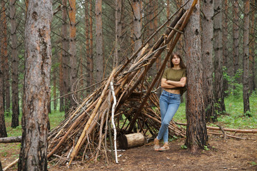 Portrait of young woman in casual clothes in the wood in summer