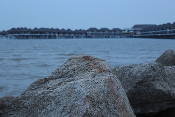 Fototapeta na wymiar Selective focus on a rock at a beach resort