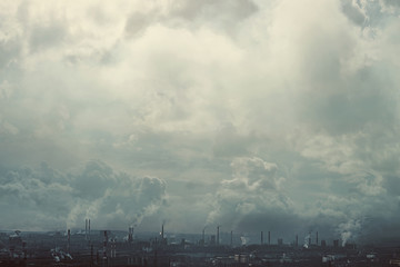 The effect of the old film. A metallurgical production complex with chimneys against a dark smoky sky. Environmental problems, environmental pollution, ecology