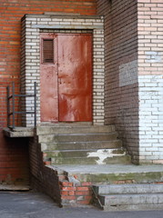 Metal brown door and stone porch