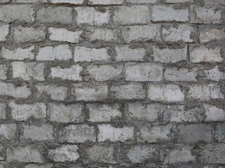 The rough surface of the wall of gray blocks