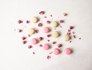 Composition of sweet macaron cookies and dry flowers on light background, Top view