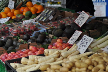 A variety of fruit and vegtables displayed on a market stall at a local farmers market.