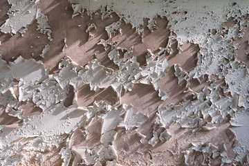 Light grey pastel wall with cracked peeling paint texture