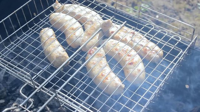Kupaty sausages on a grill. Kupaty was made from chicken and pork, intestines, pepper, onions and other spices. Stay home with family and cook barbecue during May holidays and the coronavirus pandemic