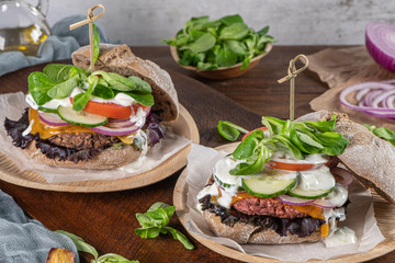 Healthy vegan burger with fresh vegetables and yogurt sauce