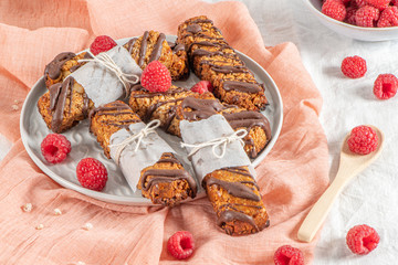 Cereal bars with raspberries on kitchen counter top.