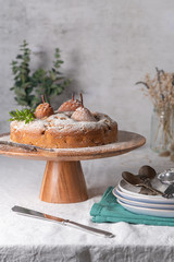 Delicious spice cake with pear, ginger and cinnamon on a white kitchen counter.