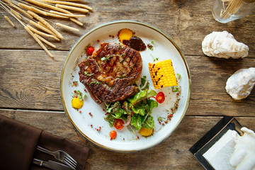 Top view appetizing grilled beef steak with corn