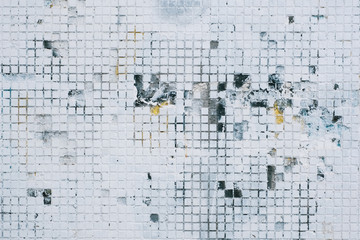 Old white mosaic tiles texture painted on top with a layer of paint. 