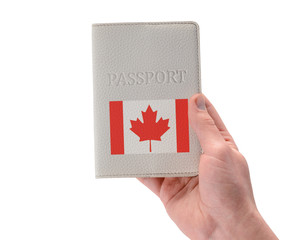 Canadian passport in a man's hand on white background